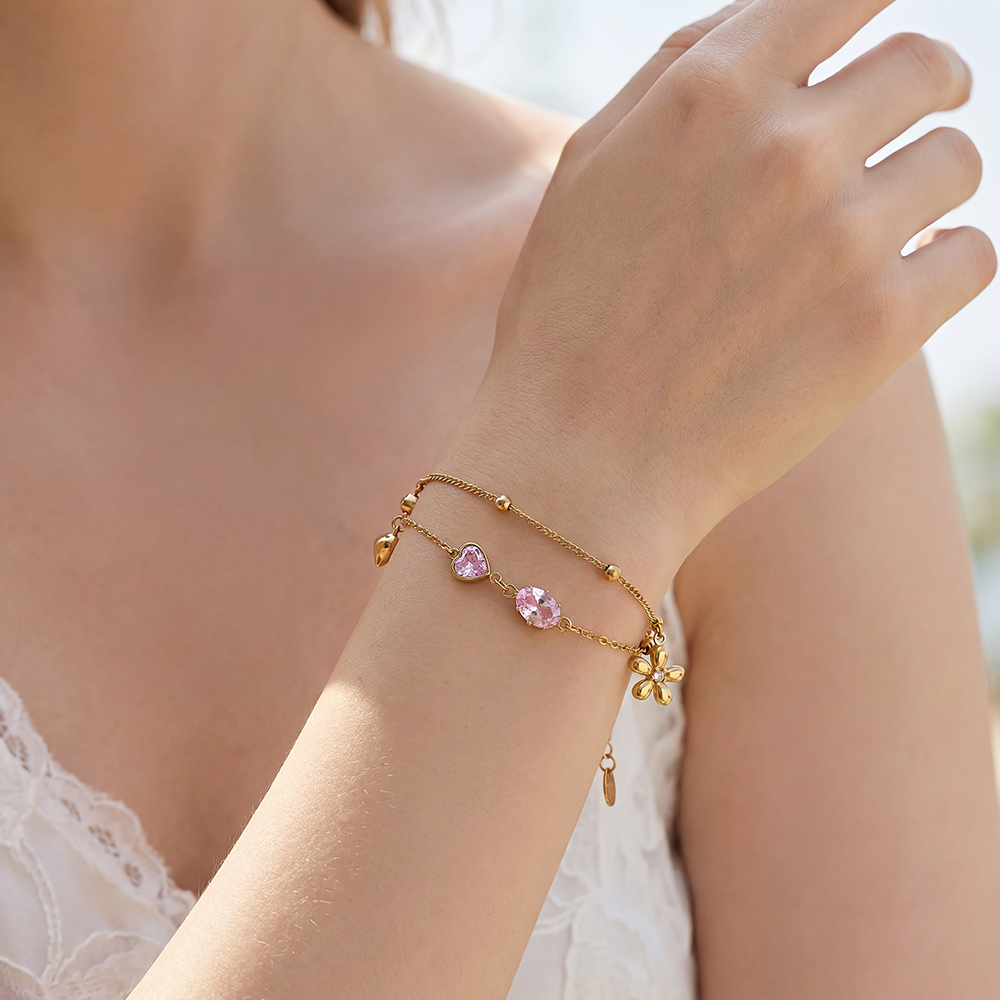 Stainless steel bracelet, 17cm, with pink cubic zirconia and a gold flower