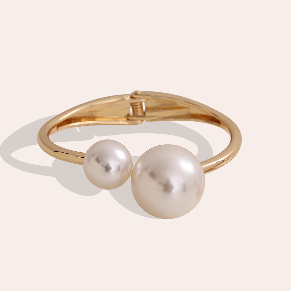 6.5cm wide round bangle with two brass beads   